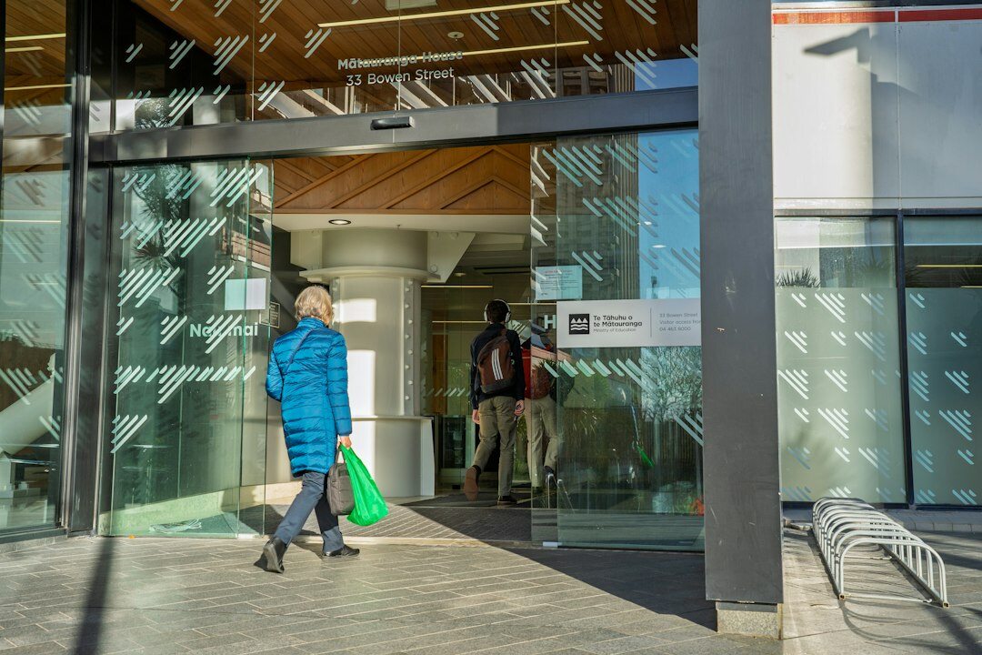 Group of professionals walking and talking together in an office corridor