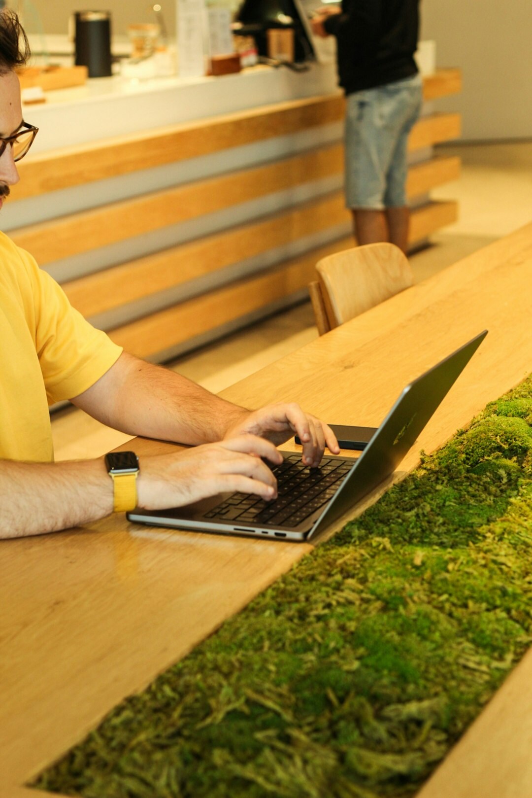 Close-up of hands typing on a laptop during a work session